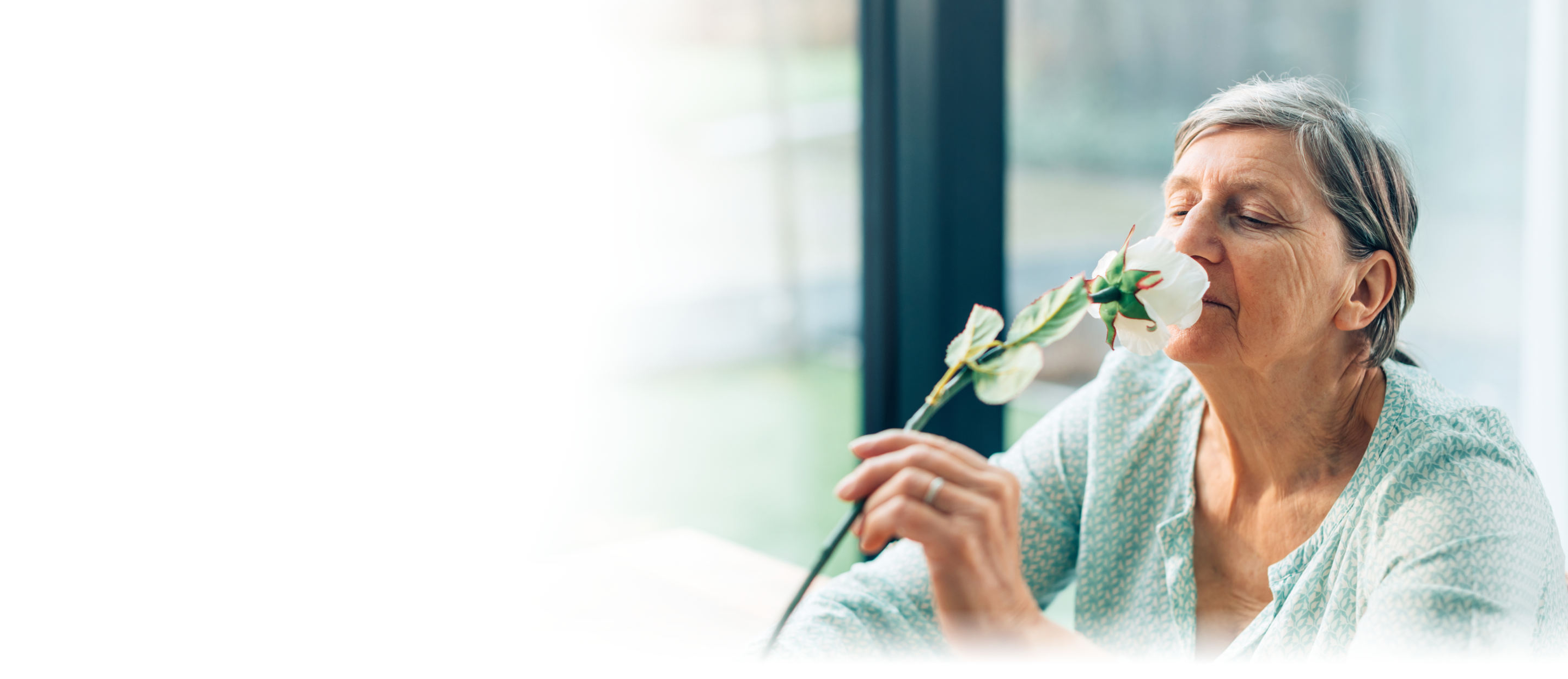 A woman smelling a flower